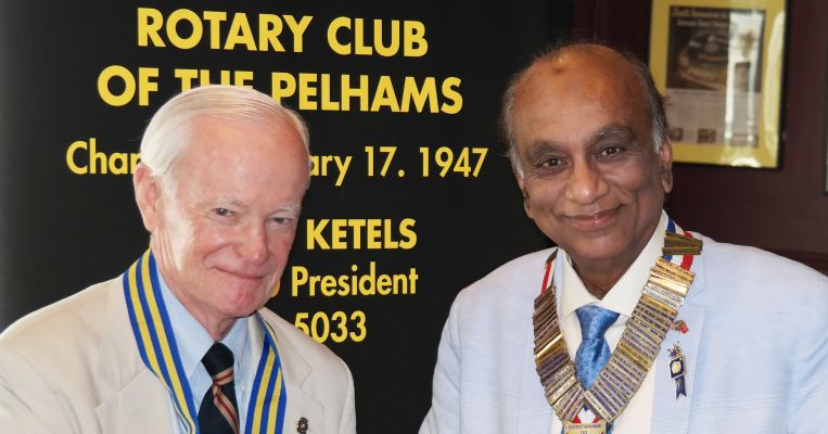 On left, new President Marty Ketels with Rotary District Governor Mahbub Ahmad.
