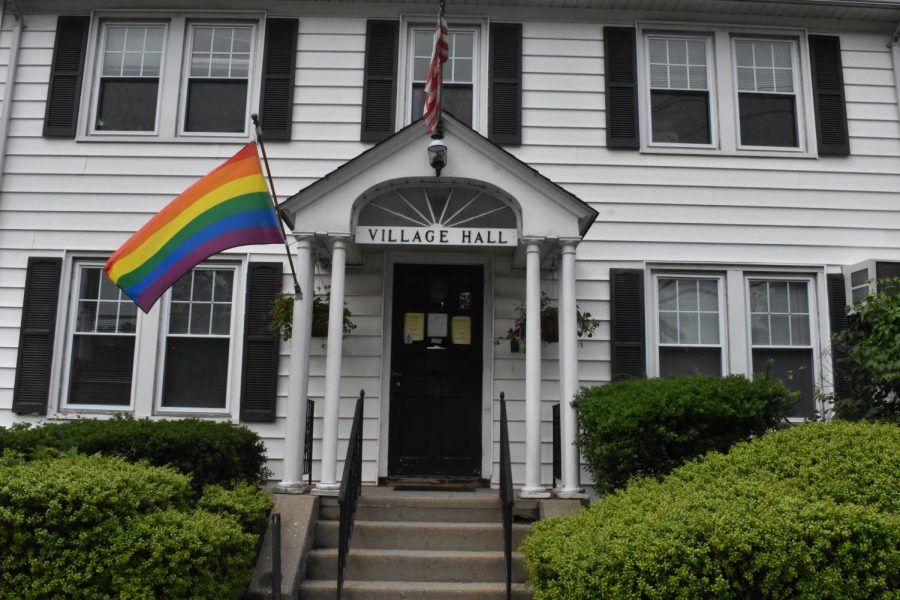 Pride flag waving at Village of Pelham Hall