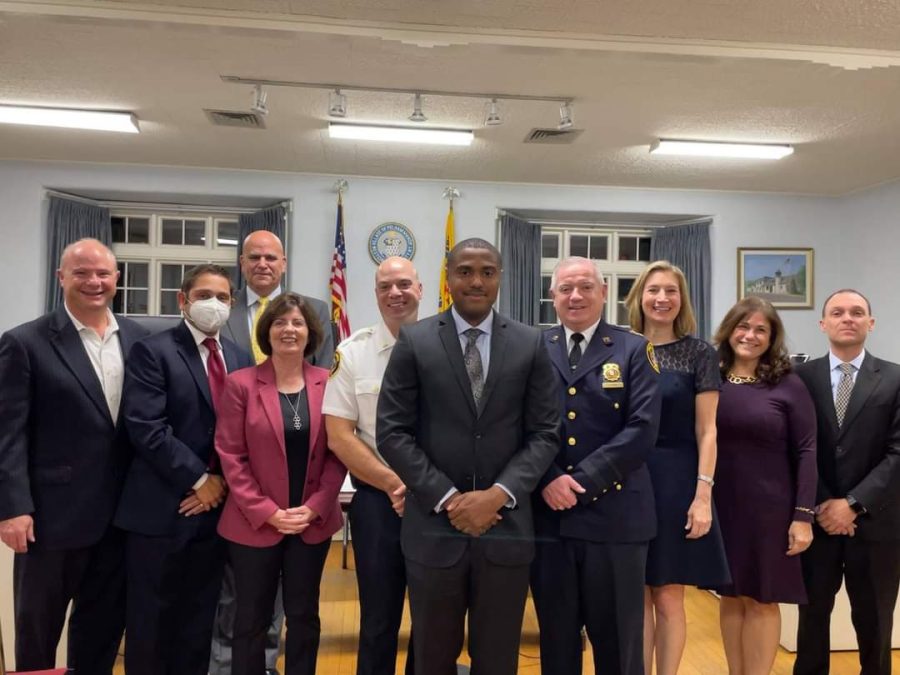 New Pelham Manor Police Officer Shecore Speid (center) after being sworn in by Mayor Jennifer Monachino Lapey (third from right). Also pictured: other members of the village board, police leadership and village administration.