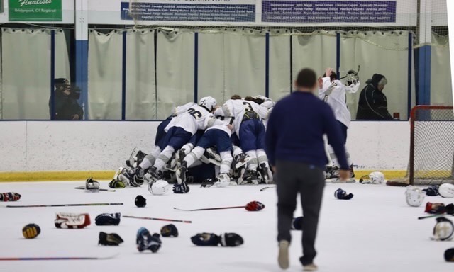 PMHS hockey dog piles after winning Section 1 championship.