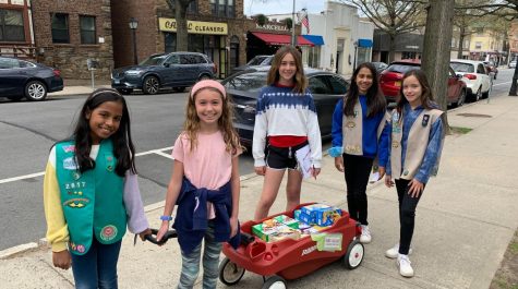 Girl Scouts sell cookies along Fifth Avenue.