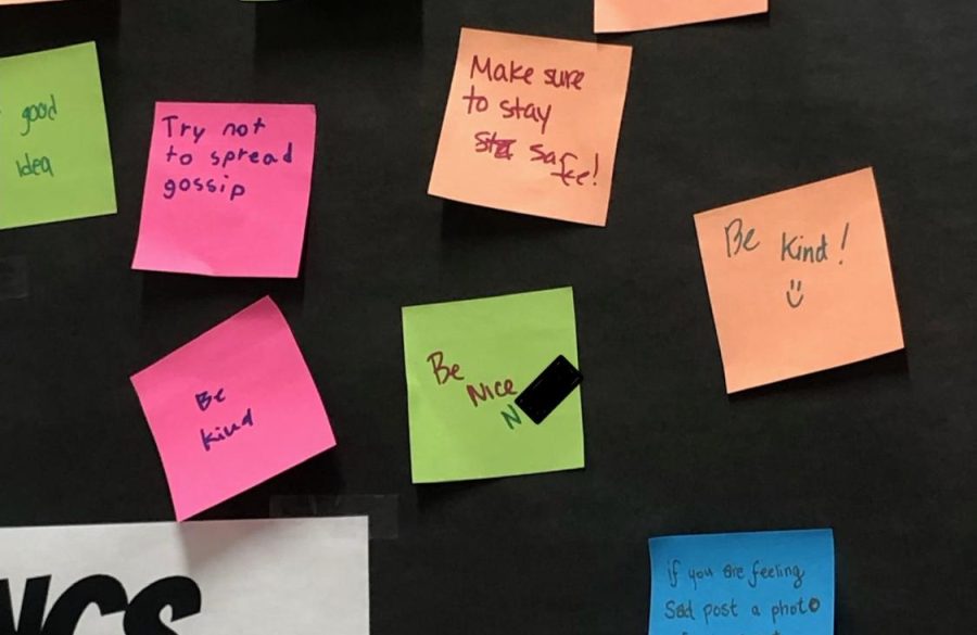 A Post-it with a message that had the N-word added (all but the n blocked out by the Pelham Examiner) along with other messages on a poster encouraging positive communication.