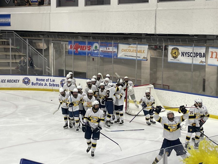 Pelham Hockey celebrates after winning state semifinals match against Saranac. 