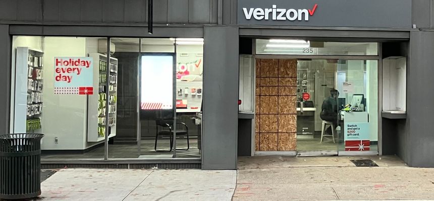 By Friday afternoon, a sheet of particle board replaced the broken window at the Verizon store.