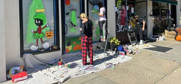 Foto Feature: PMHS students paint store windows with outer space images for Halloween