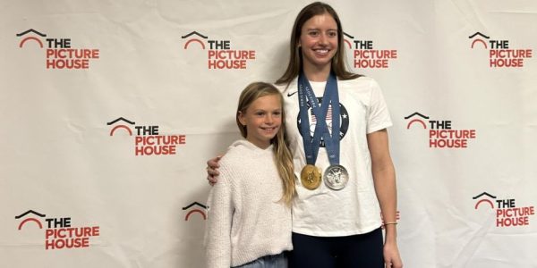 One of Kate Douglass's fans poses with her for a keepsake photo. Douglass took pictures with a line of attendees that wrapped around the theater.