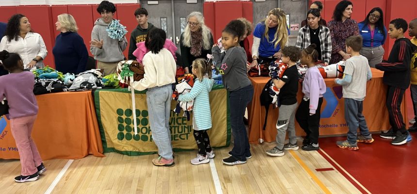 Pelham senior citizens and PMHS students handout handmade blankets to kids in New Rochelle YMCA programs