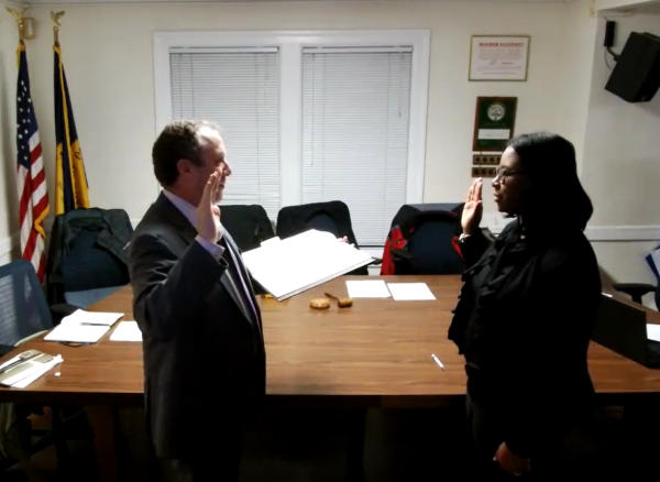 New Trustee Krystal Howell (right) is sworn in by Mayor Chance Mullen.