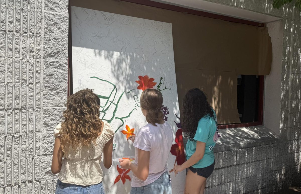 Members of the Teen Artists Council creating the mural.