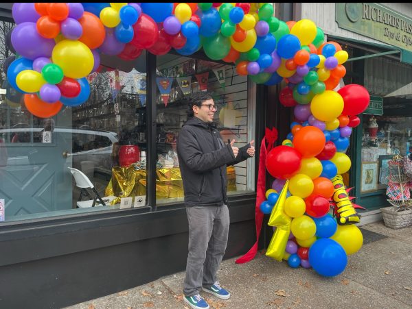 Cabrera standing outside Pelham Comics and Collectibles at the opening ceremony. 