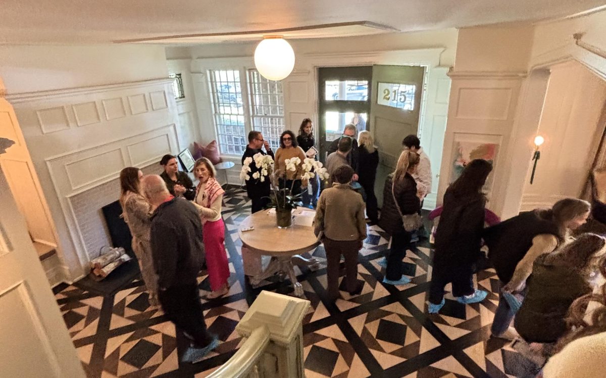 Music drifts through the door as attendees wander 215 Loring Avenue