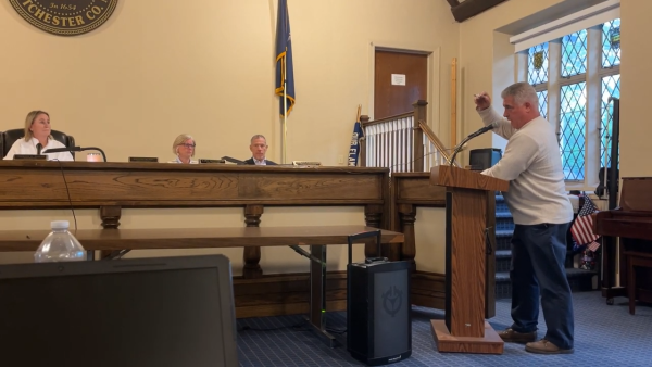 Retired firefighter John Marsich addresses Town Supervisor Theresa Mohan and the council.